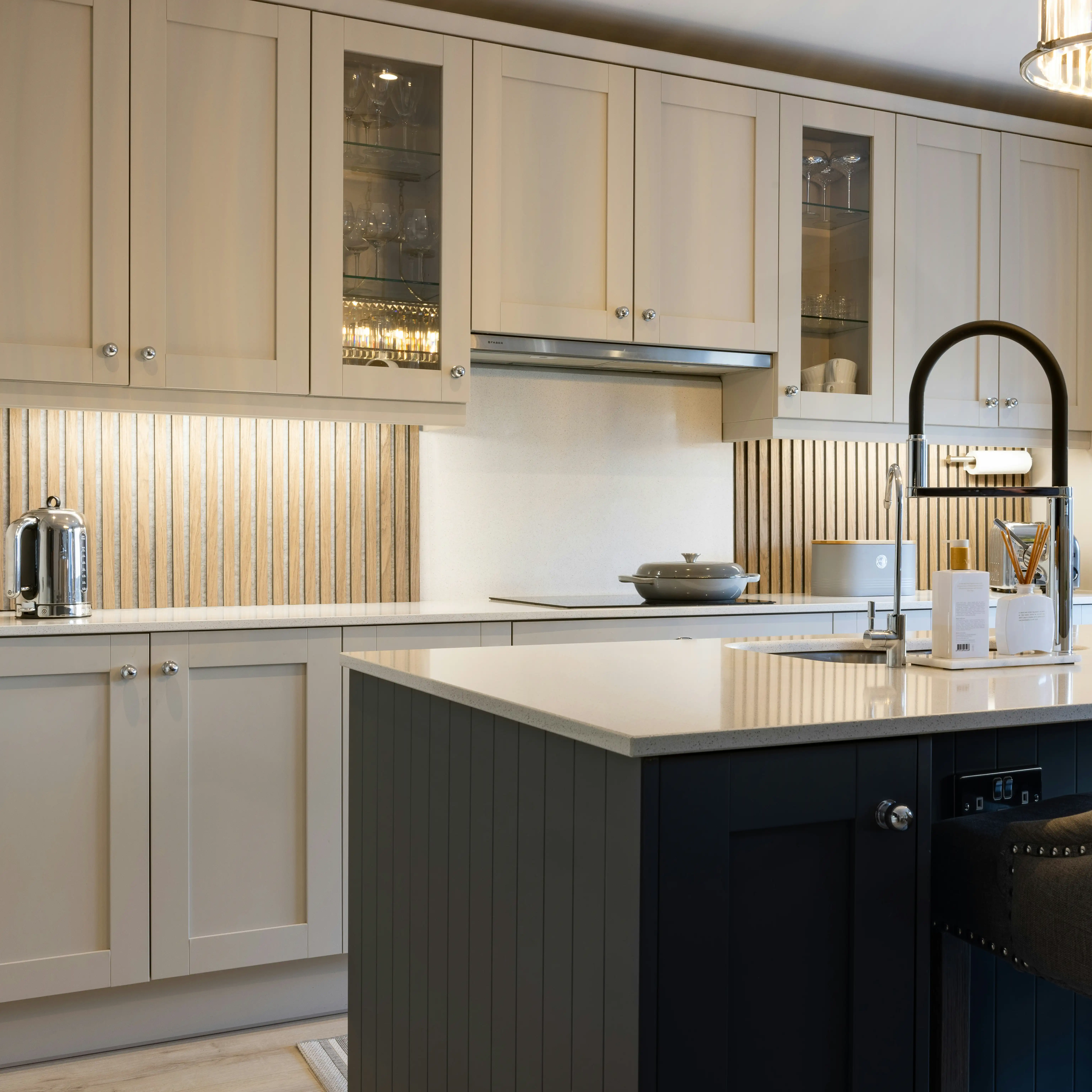 A clean and simple kitchen with modern dark kitchen island with sink